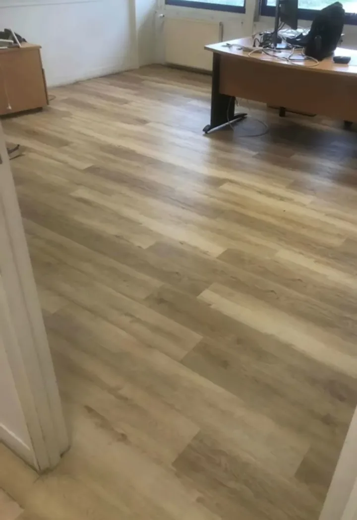 Sol vinyle imitation bois posé dans un bureau après dépose de l'ancien revêtement